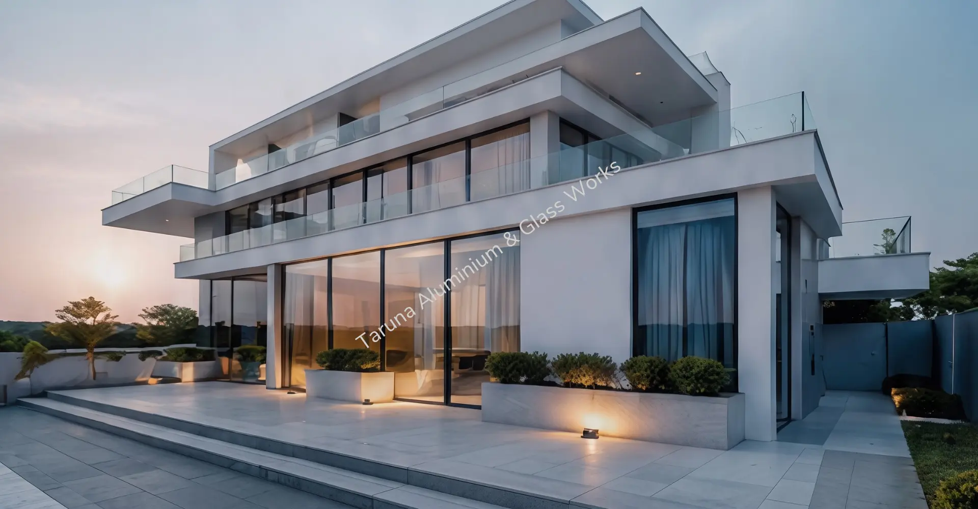 Modern luxury villa featuring premium aluminium windows and glass façade by Taruna Aluminium and Glass Works